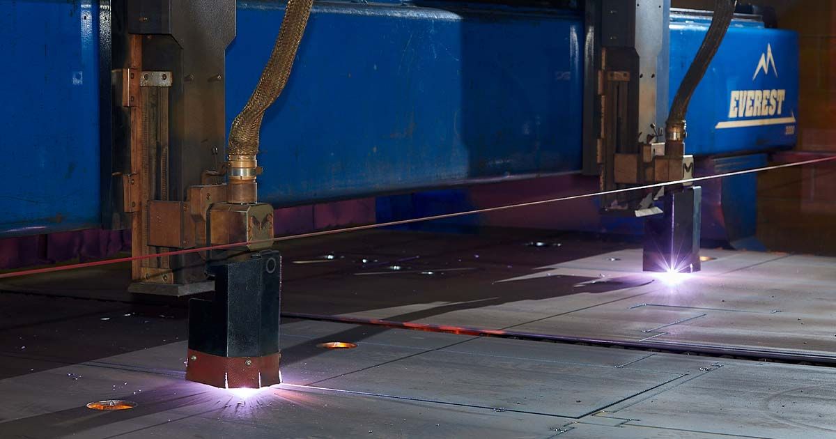  Industrial plasma cutting machine cutting through thick metal sheets with precision.